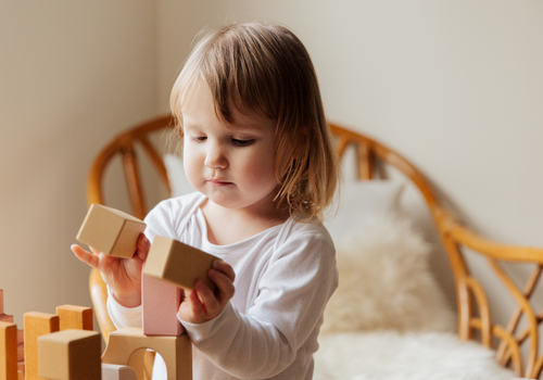 young girl playing with blocks