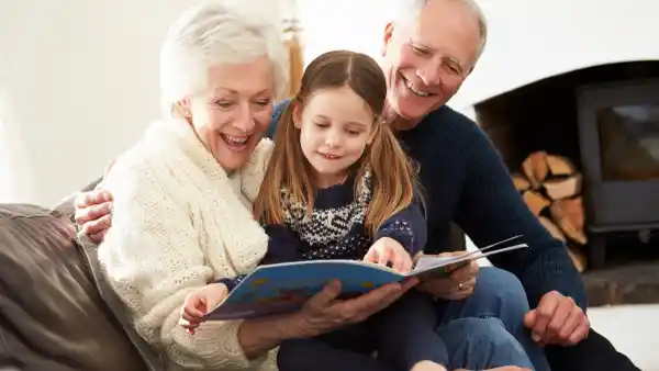 grandparents reading with grand child