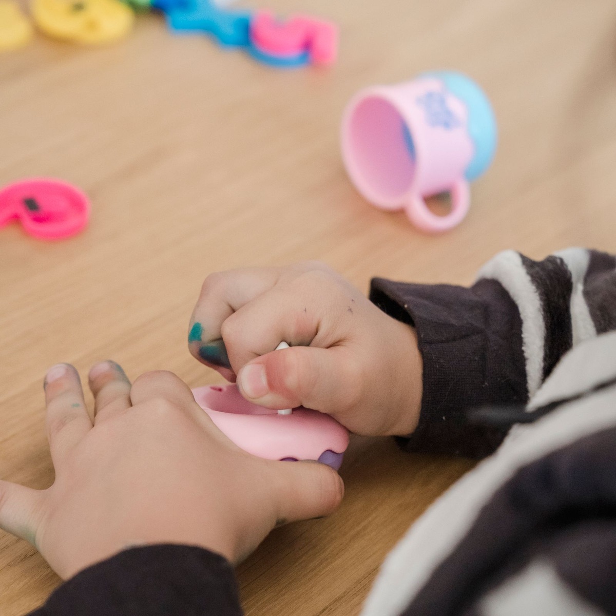 Child practicing fine motor skills with a sensory toy for ABA therapy near me