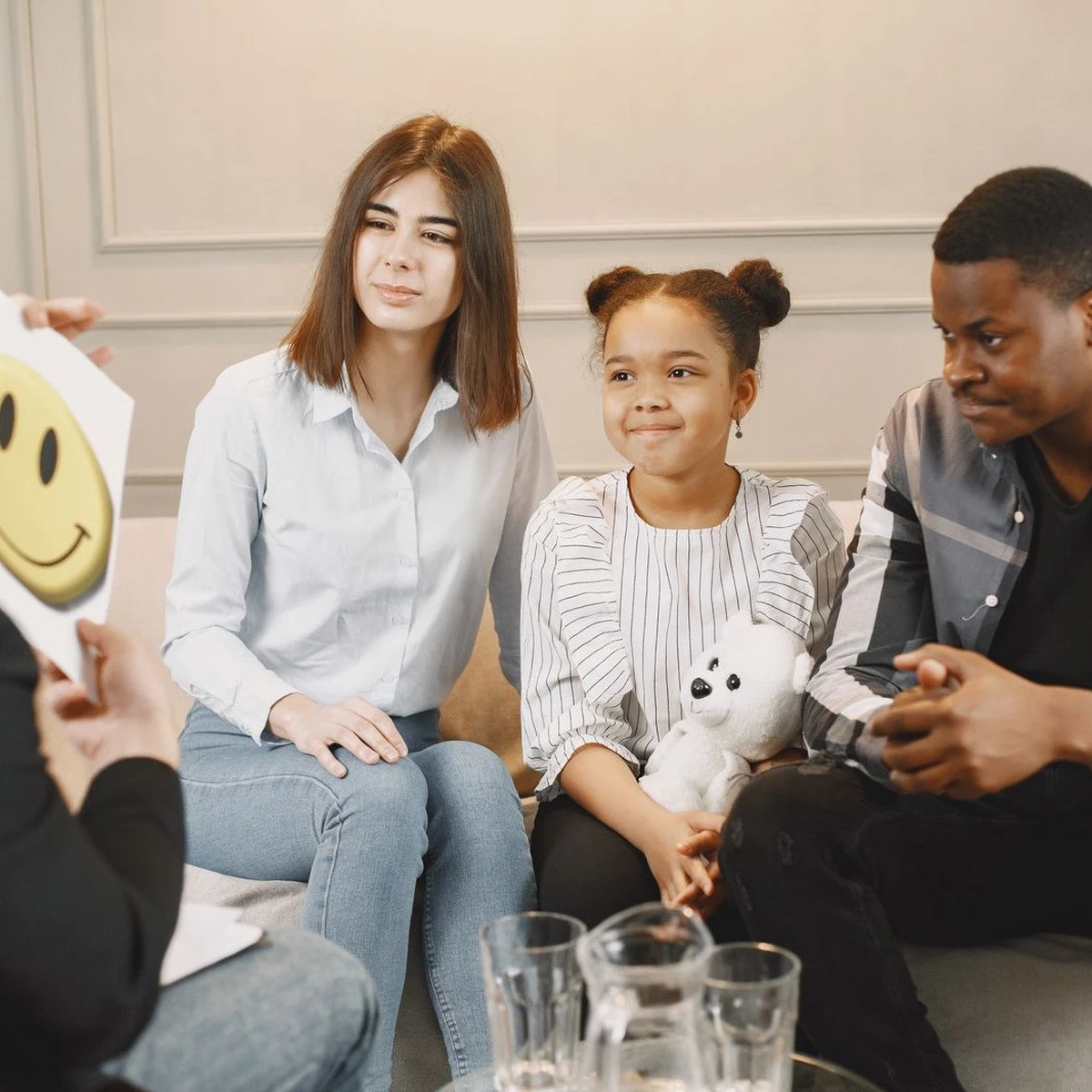 Child participating in a supportive therapy session with adults for ABA therapy near me
