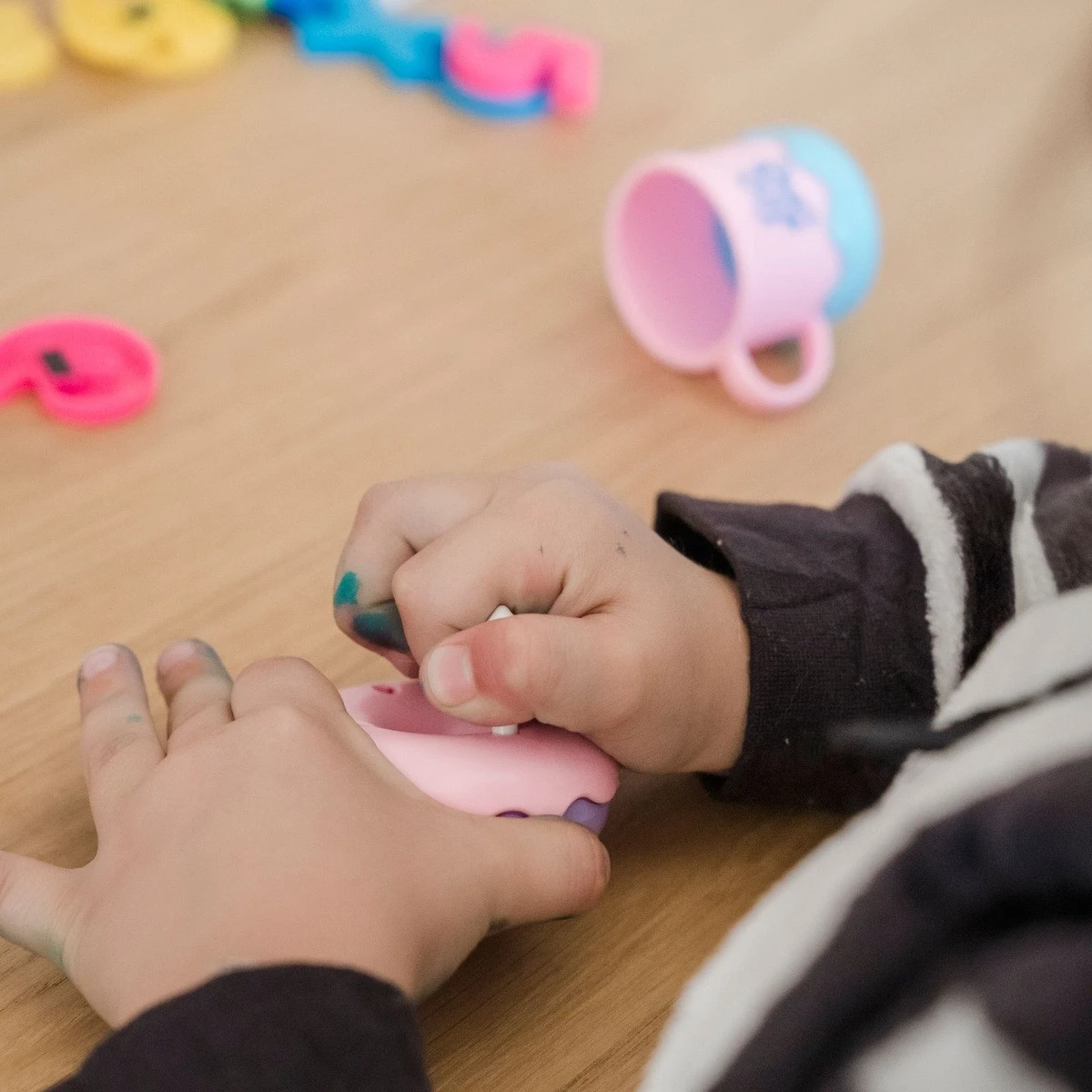 Child practicing fine motor skills with a sensory toy for ABA therapy near me